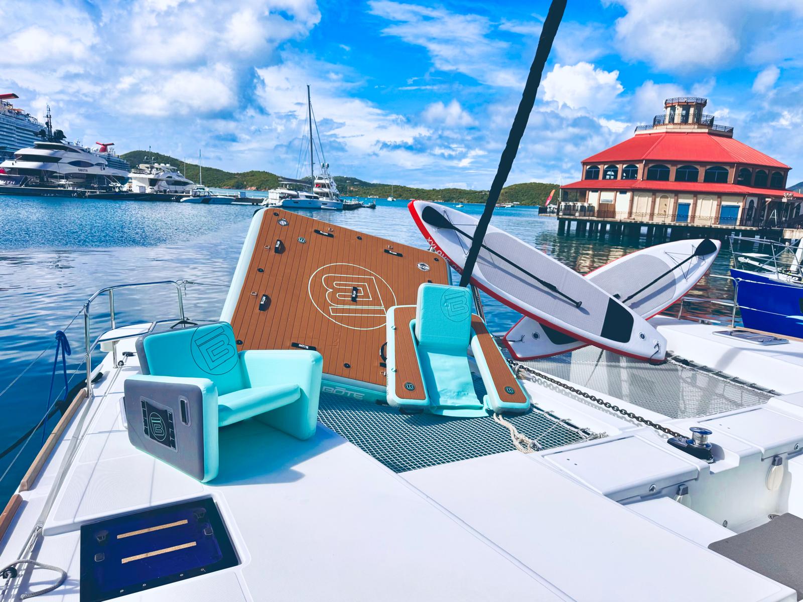 Floating dock with paddleboards and water toys