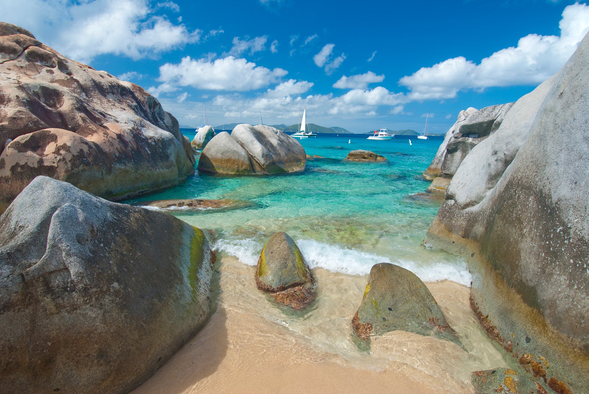 The Baths Virgin Gorda BVI granite boulders with turquoise water and sailboats