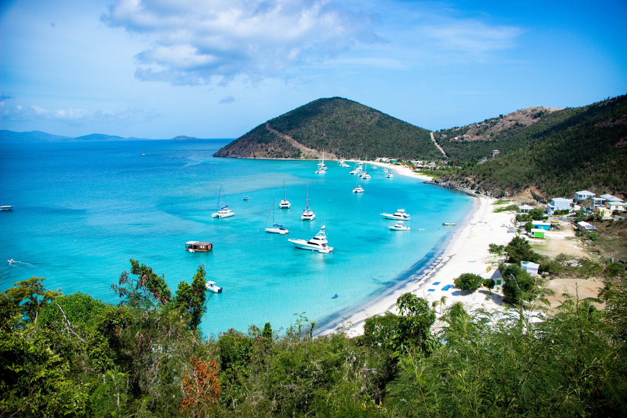 Aerial view of White Bay, Jost Van Dyke BVI with turquoise water and moored yachts